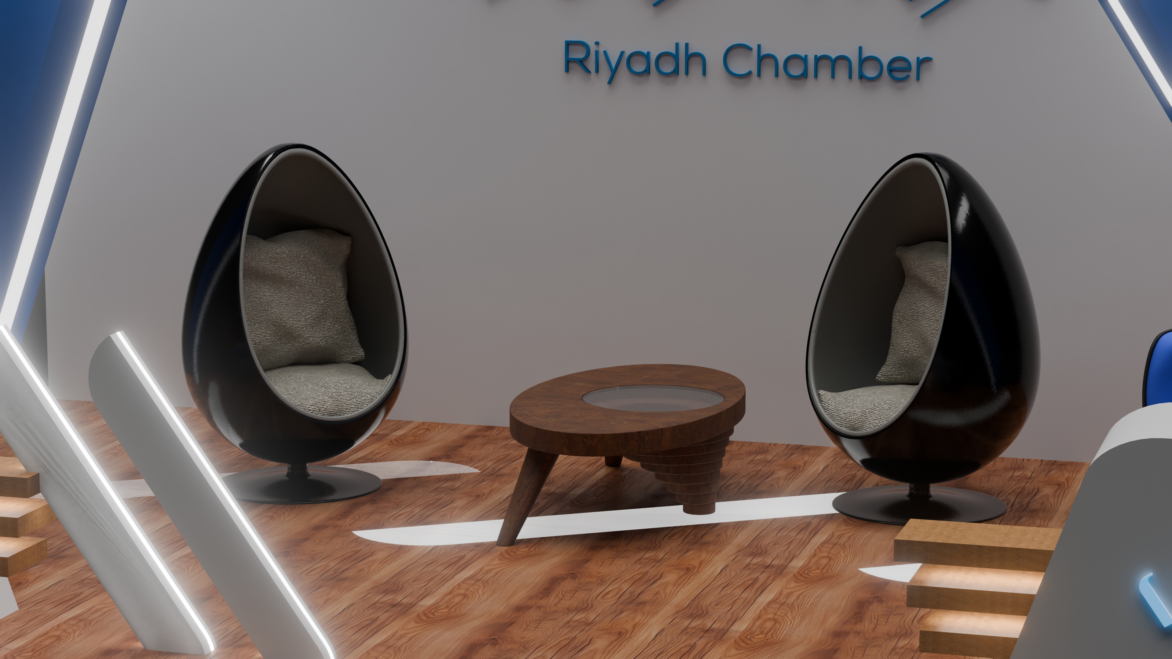 Riyadh Chamber visitor lounge with two pod chairs, a central table, illuminated dividers, and wall branding inside the exhibition booth.