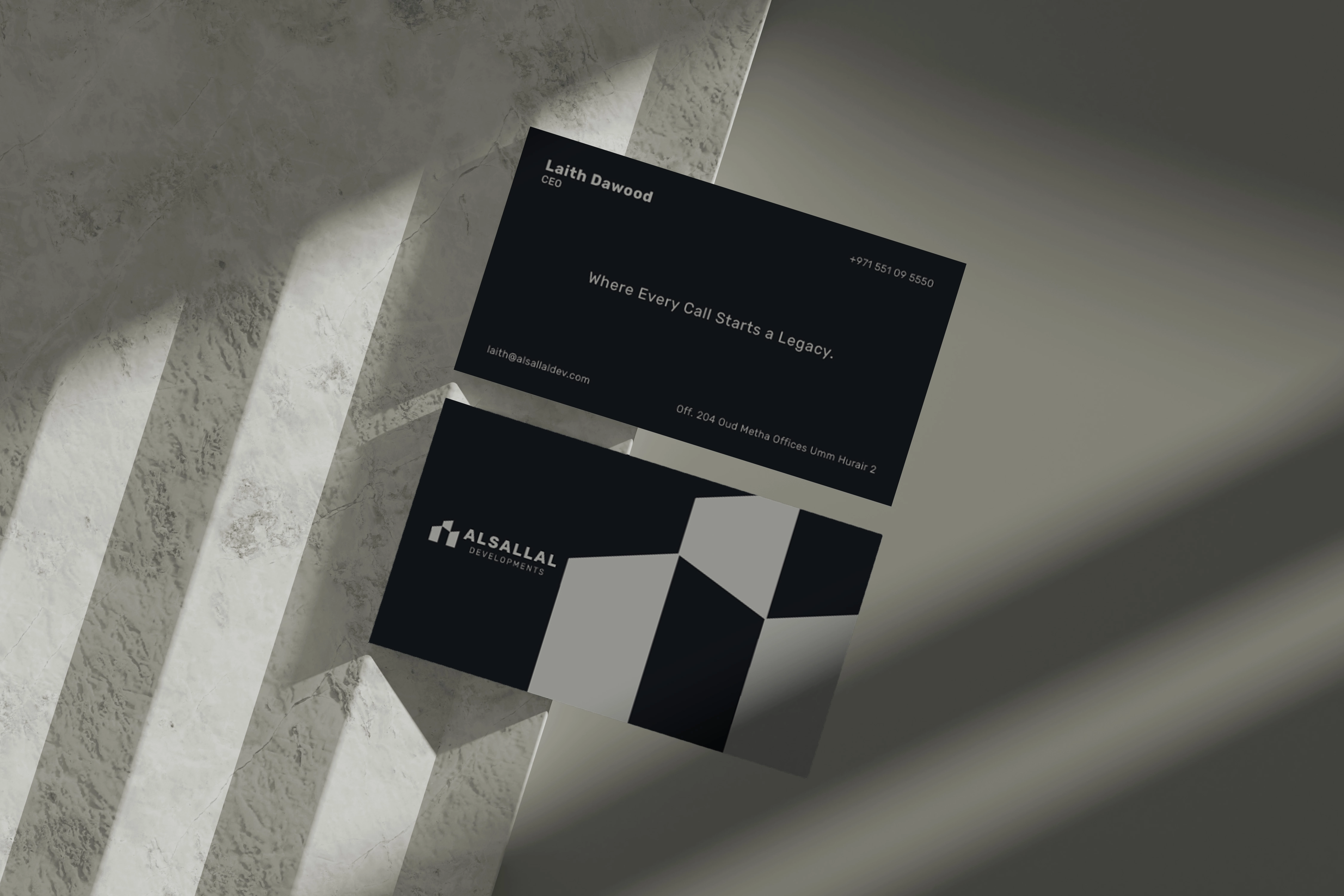 Charcoal Alsallal Developments business cards with copper accents and modular building forms.