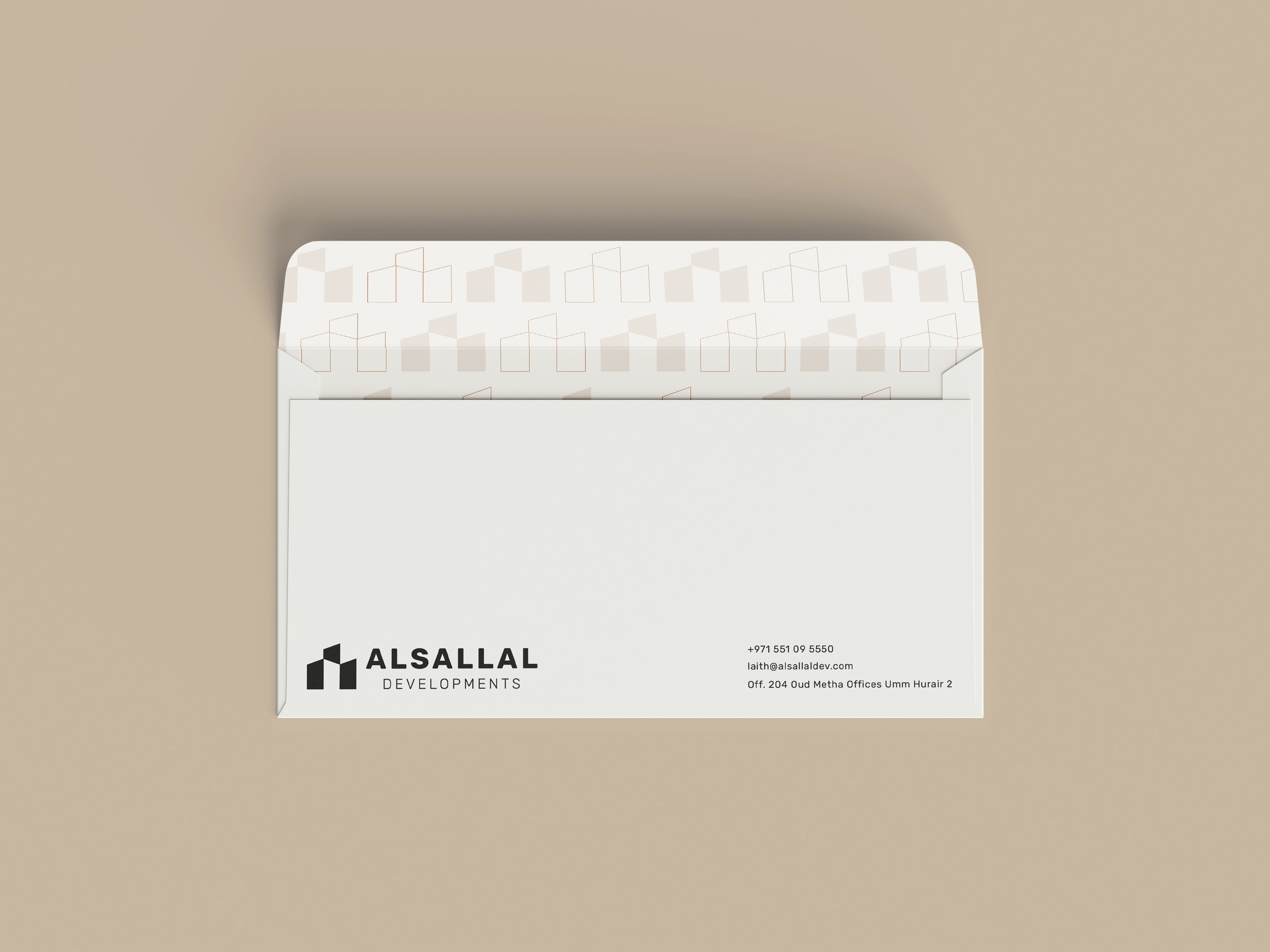 Ivory Alsallal Developments envelope with a copper architectural pattern inside the flap.