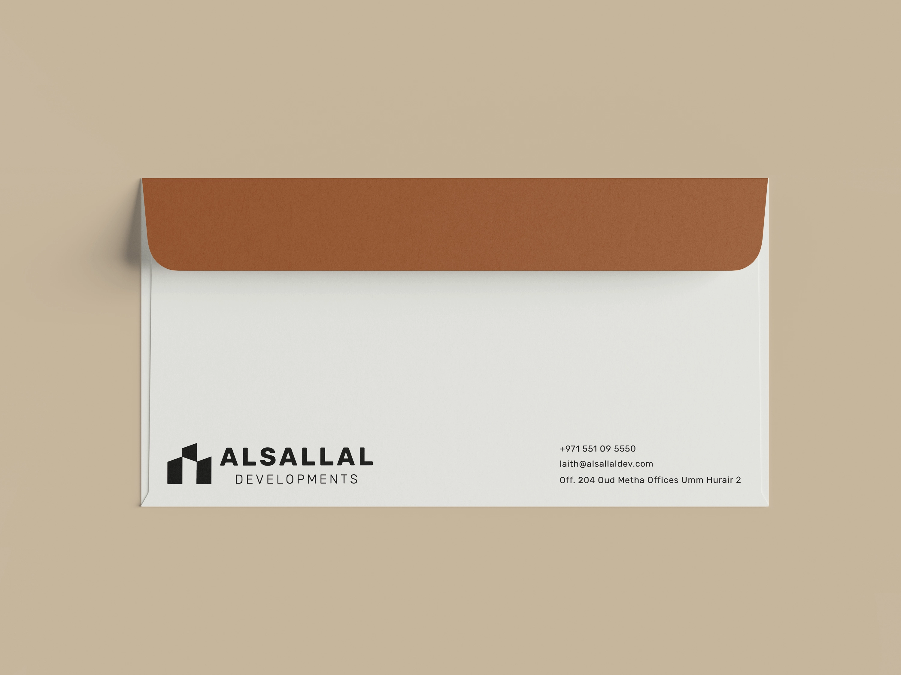 Flat ivory Alsallal Developments envelope with a solid burnished copper flap.