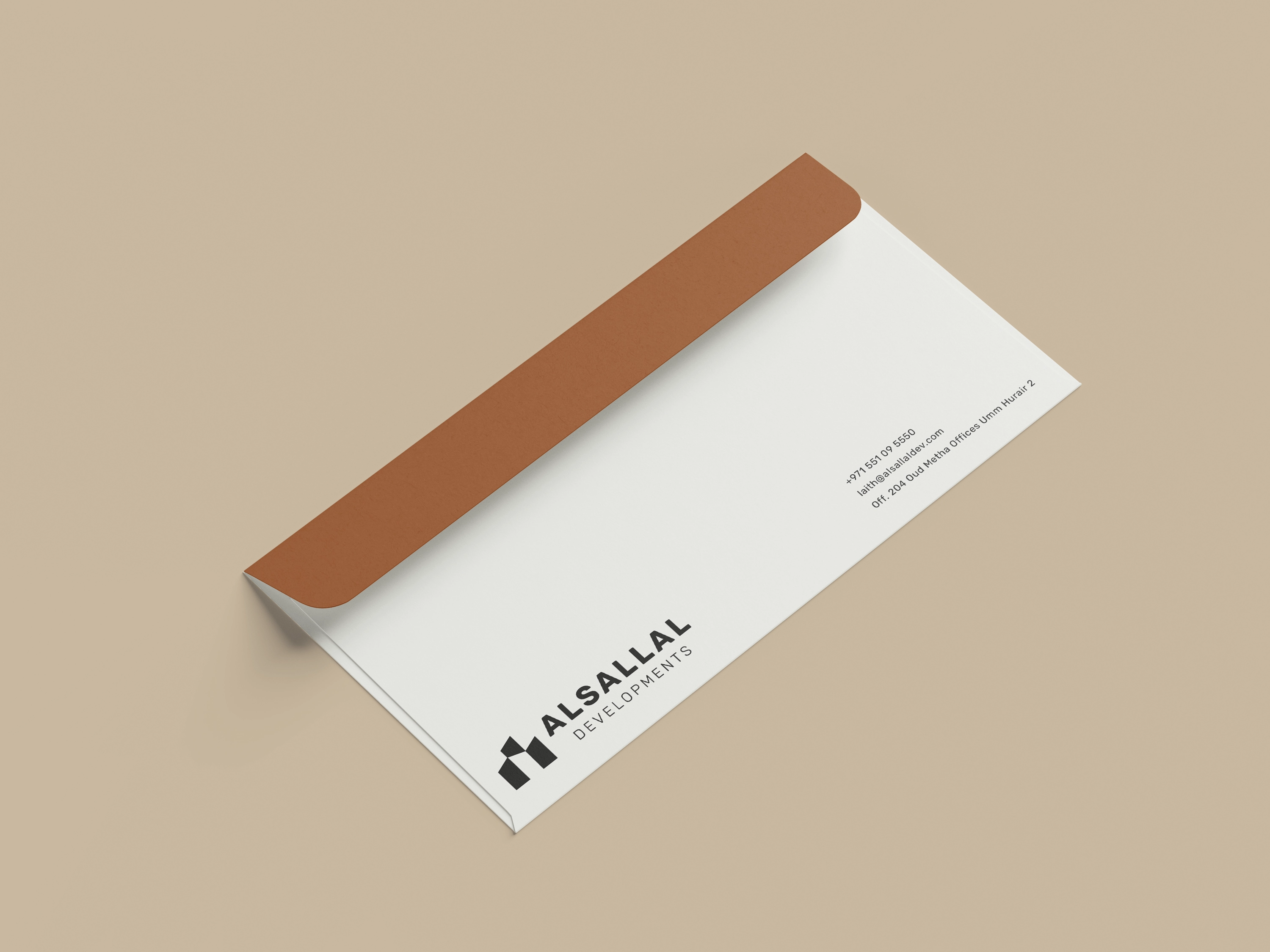 Minimal Alsallal Developments envelope with a warm metallic flap and compact address block.