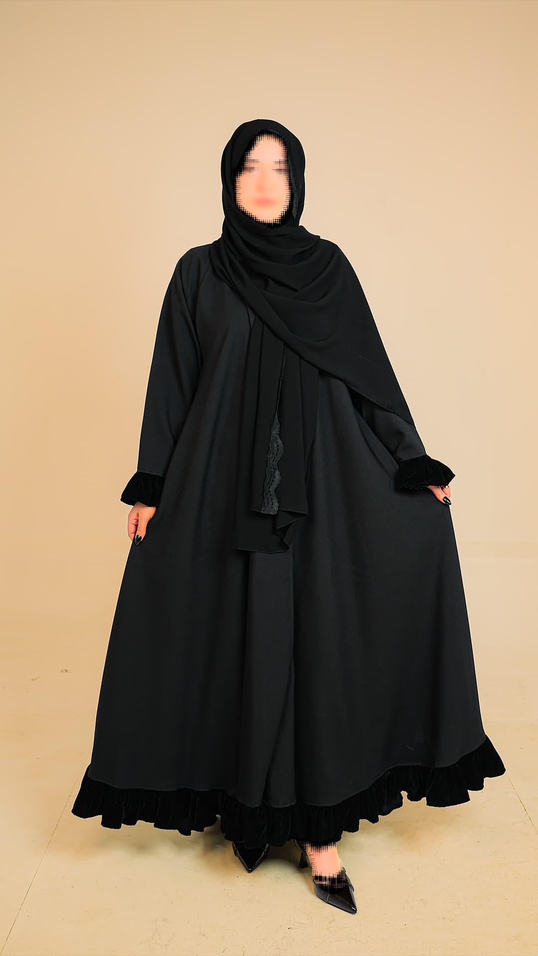 Original product photography for Rilam showing a black layered abaya against a plain studio background.