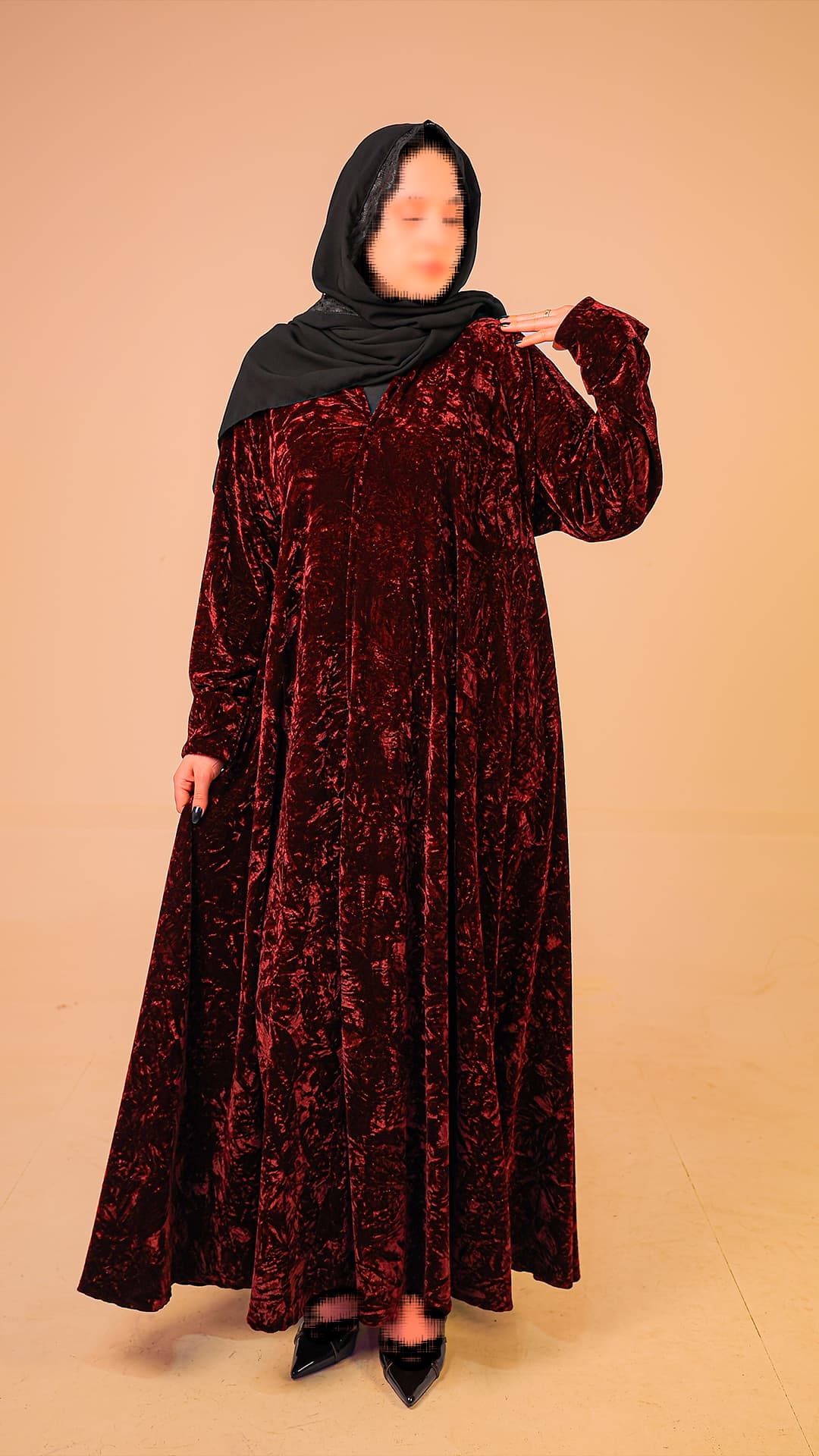 Original product photography for Rilam showing a burgundy velvet abaya against a plain studio background.