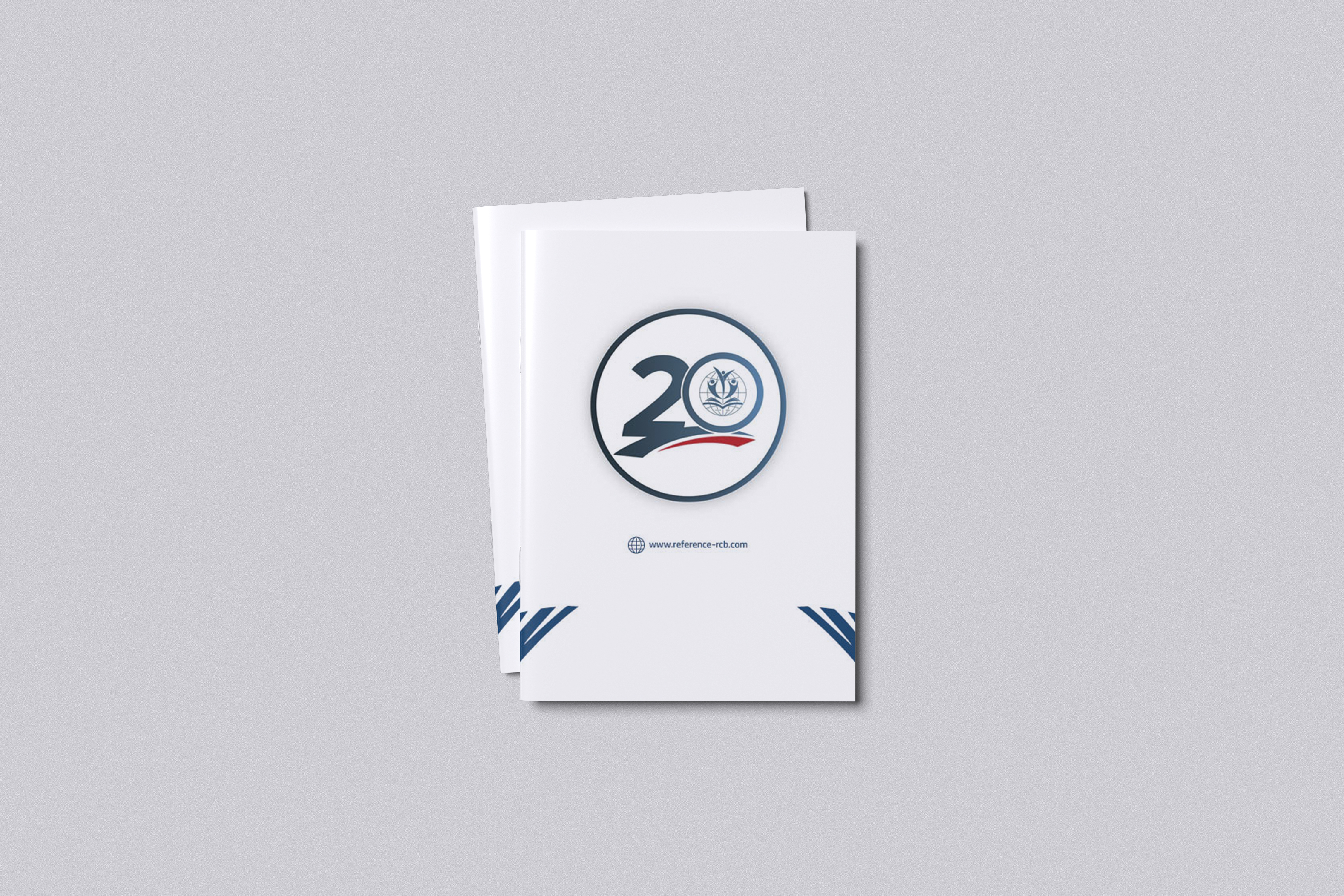Standing mockup of the Reference Arabic health-education booklet with its anniversary identity on the white cover.