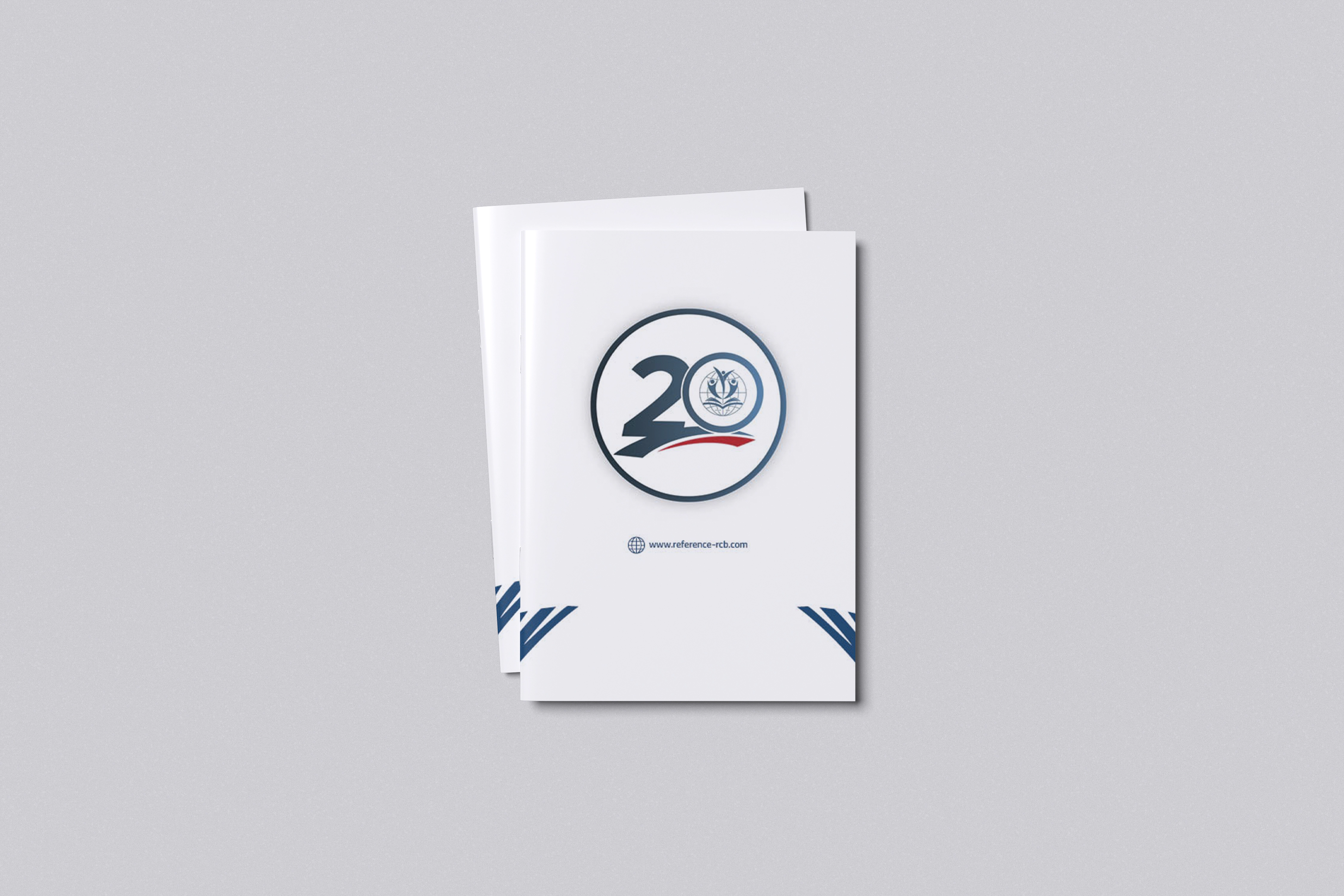 Standing mockup of the Reference Arabic health-education booklet with its anniversary identity on the white cover.